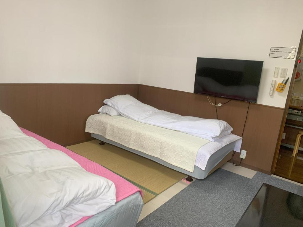 Postel nebo postele na pokoji v ubytování Oyama Guesthouse Kyoto