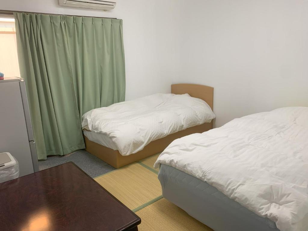 Postel nebo postele na pokoji v ubytování Oyama Guesthouse Kyoto