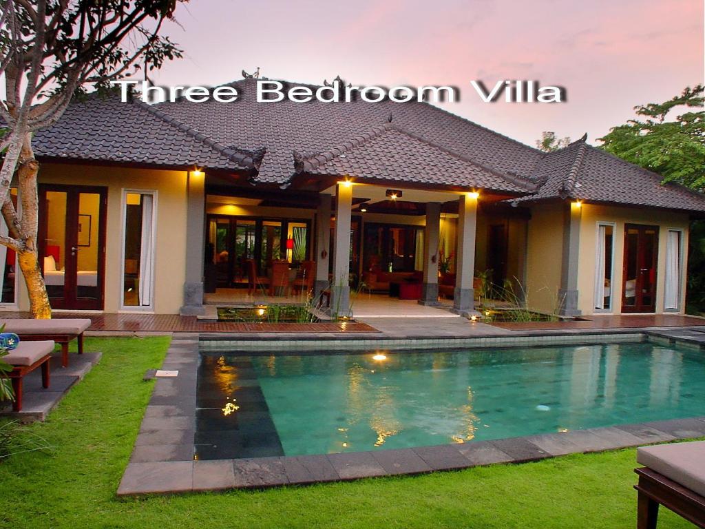 a swimming pool in front of a villa at Villa D'Suite in Seminyak