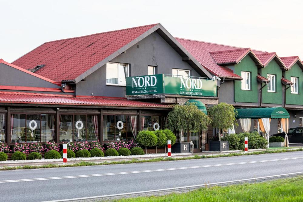 a building on the side of a road at Hotel NORD in Mierzyn