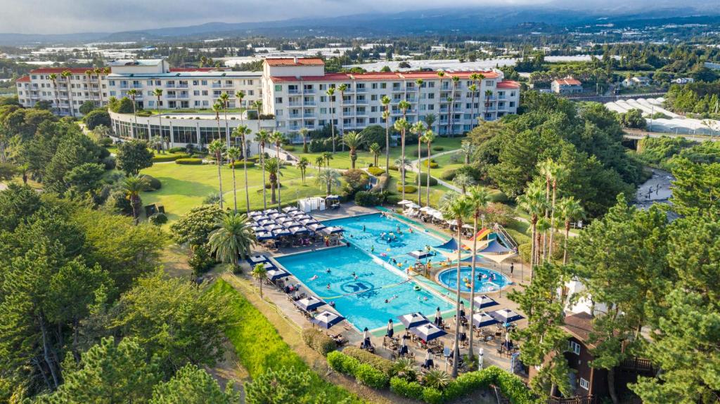 an aerial view of a resort with a swimming pool at Kensington Resort Seogwipo in Seogwipo
