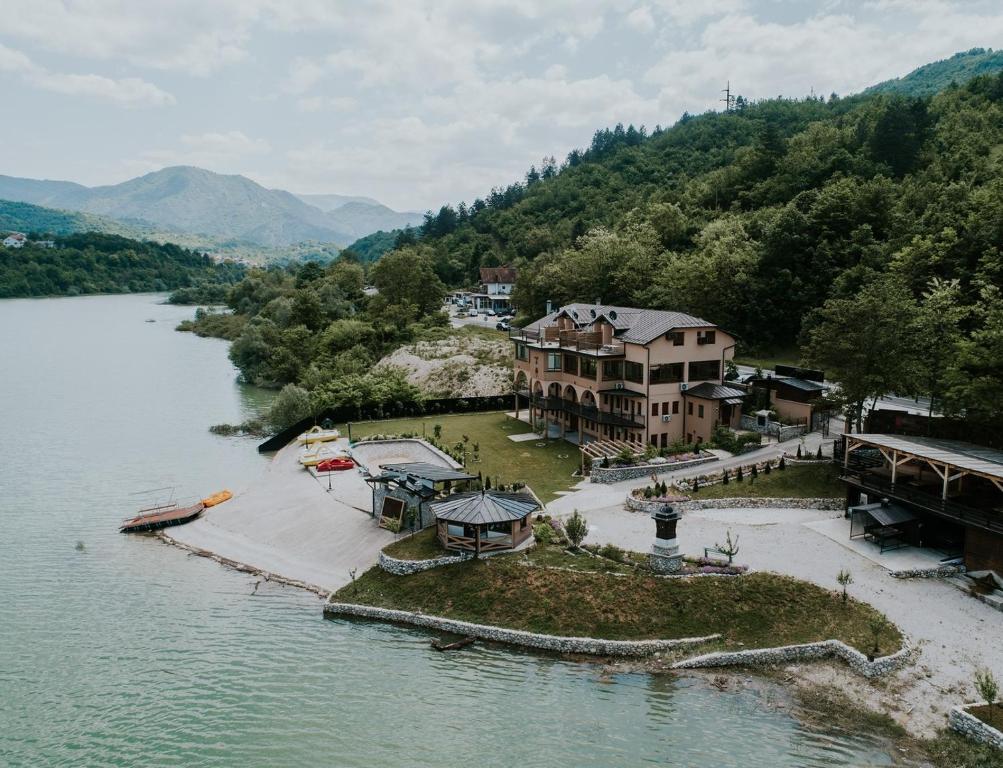 an aerial view of a house on an island in the water at Hotel Noor Konjic in Konjic