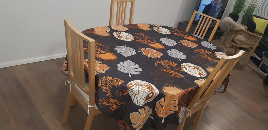 a dining room table with a butterfly patterned cloth on it at Joanna Apartment - MA Casterfeld Haus in Mannheim
