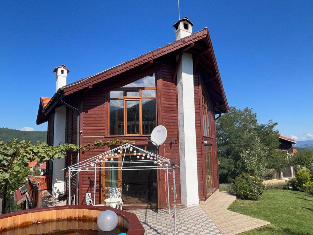 a small wooden house with a satellite at Large Luxury Chalet in Raduil, nr Borovets - hot tub, views, Wi-Fi in Raduil