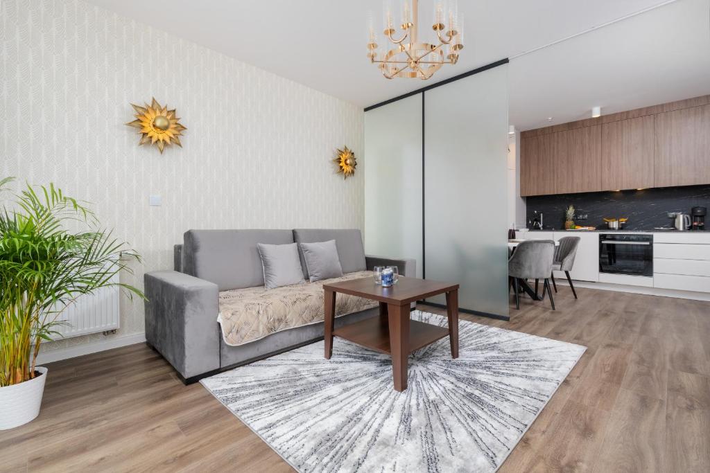 a living room with a couch and a table at Stunning Apartment with Parking in Gdansk Lower Town by Renters in Gdańsk