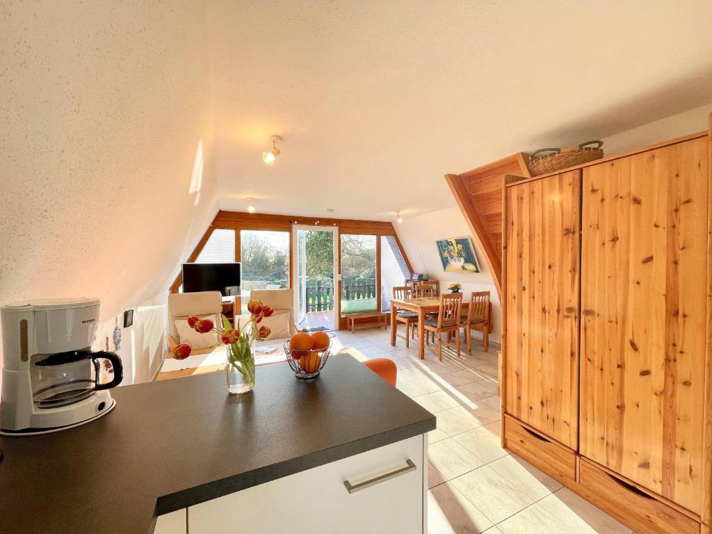 a kitchen and living room with a counter and a microwave at Finnhütten Mönchgut Finnhütte 67 in Gager