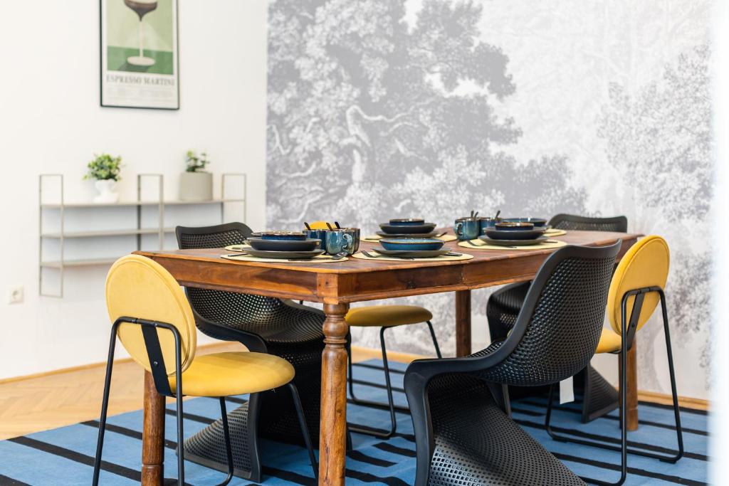 a dining room with a wooden table and chairs at City Center Apartment with Balcony in Budapest