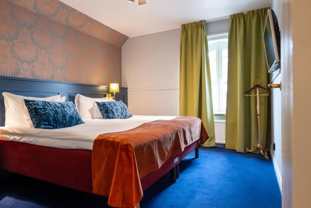 Postel nebo postele na pokoji v ubytování ProfilHotels Calmar Stadshotell