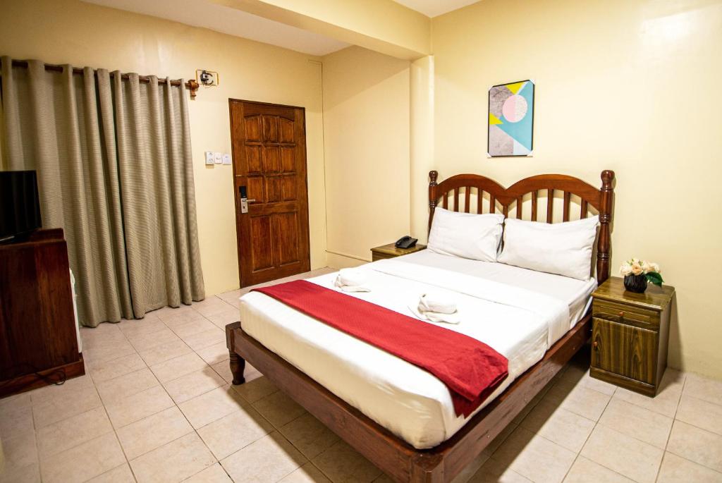 Postel nebo postele na pokoji v ubytování Kiwi Hotel