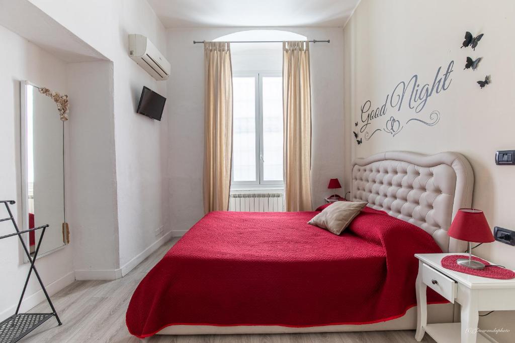 a bedroom with a red bed with a red blanket at Sapore di mare 5 Terre Affittacamere in La Spezia