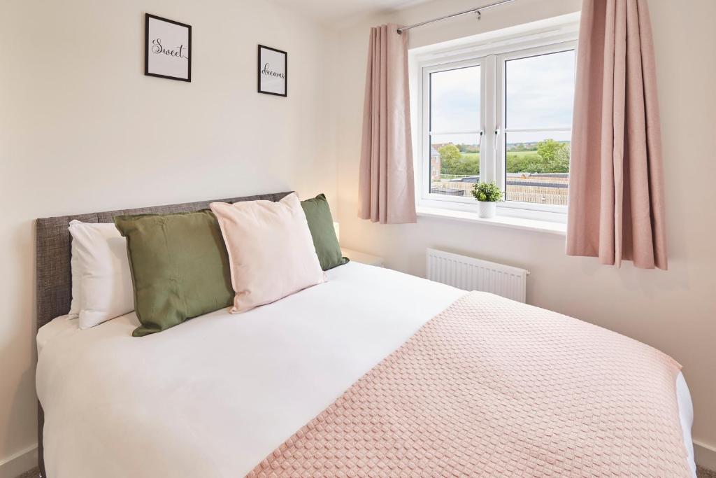 a bedroom with a white bed and a window at Host & Stay - Cayton Bay Cottage in Cayton