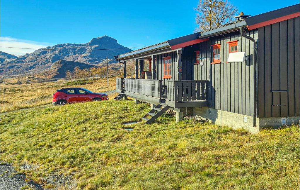 a red car parked in front of a house at Stunning Home In Beitostlen With 3 Bedrooms in Beitostøl