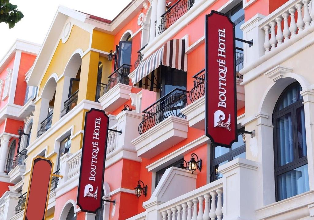a building with signs on the side of it at P Boutique Hotel - Grand World Phú Quốc in Phu Quoc
