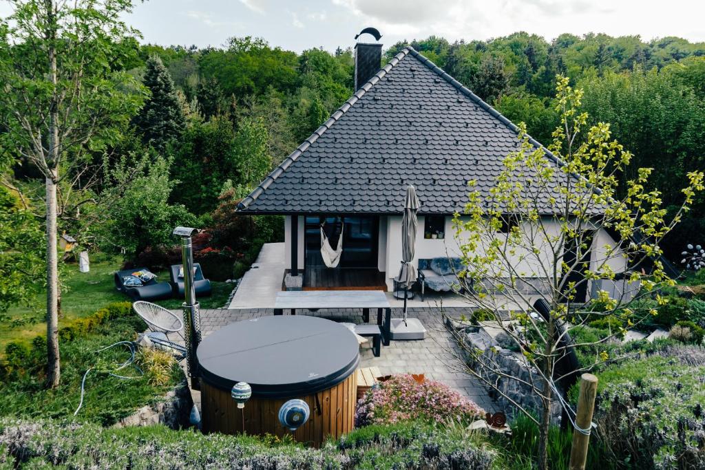 a small cottage with a hot tub in a garden at Private Lake House Selce 