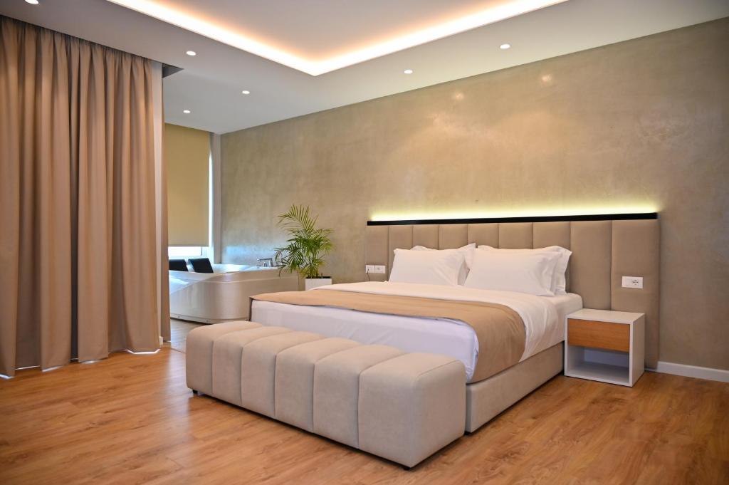 a large bedroom with a large bed and a bathroom at Hotel Zanzi in Durrës