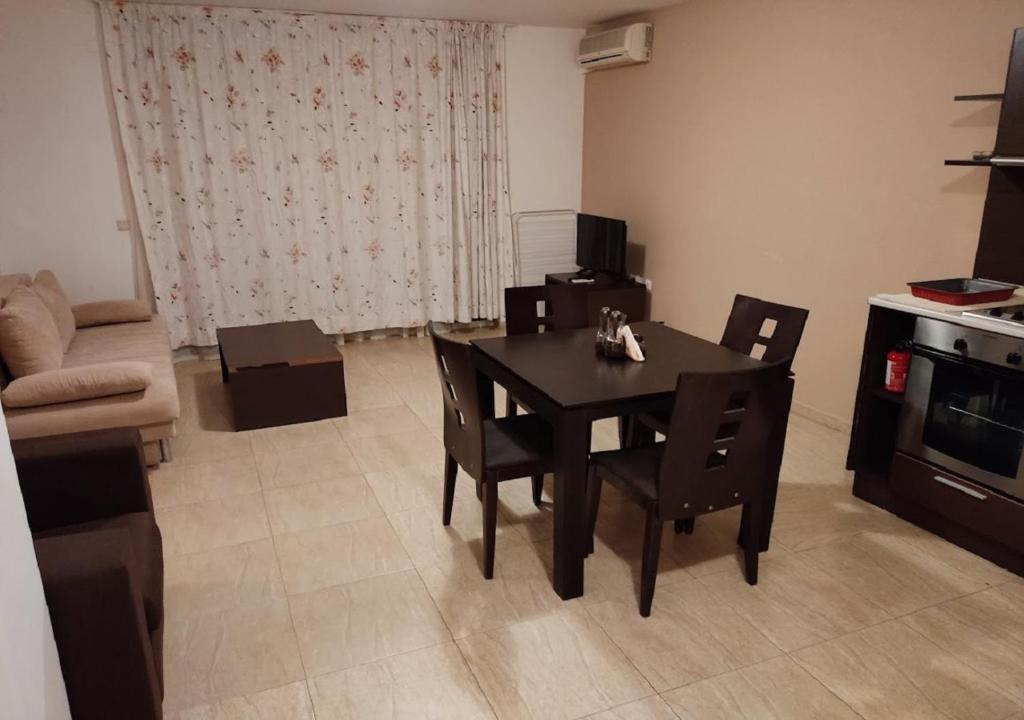 a living room with a table and chairs and a couch at Kims One-bed Apart for rent at Sunny Beach Resort in Sunny Beach