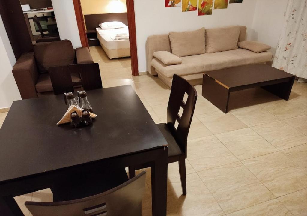 a living room with a table and a couch at Kims One-bed Apart for rent at Sunny Beach Resort in Sunny Beach