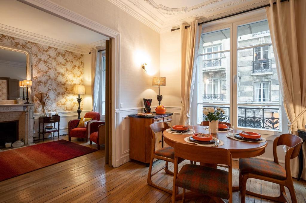 - un salon avec une table et des chaises dans l'établissement Appartement de charme à Montmartre, à Paris