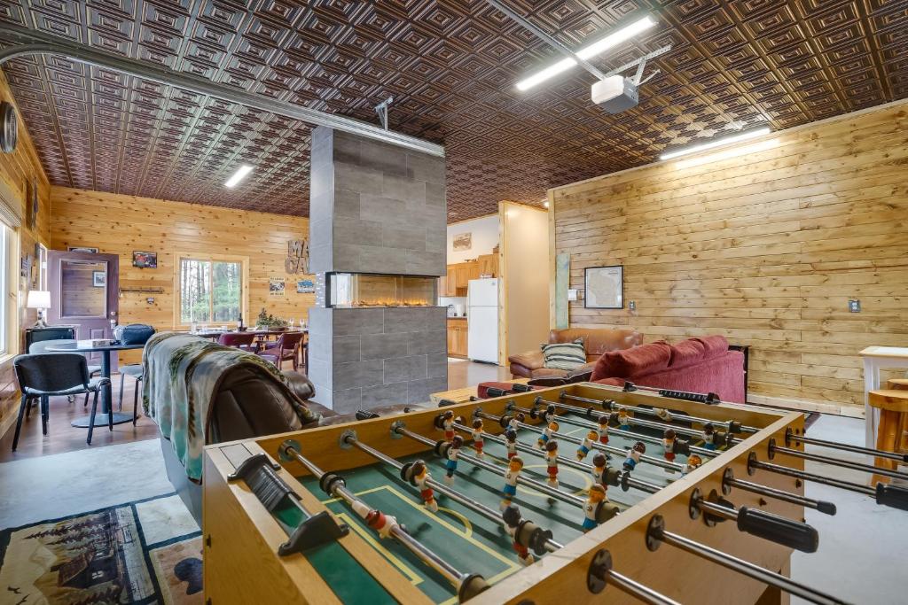 a room with a foosball table in the middle of a room at Pet-Friendly Cabin Retreat Walk to Lake Pepin! in Stockholm