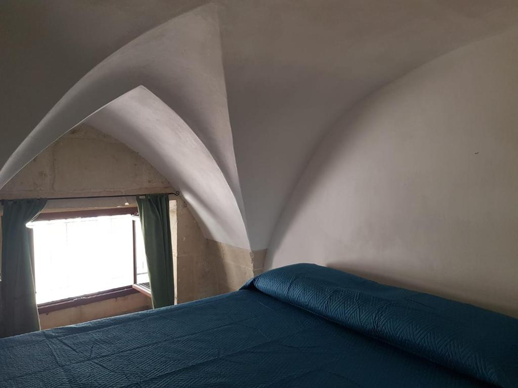 A bed or beds in a room at La casetta del Salento