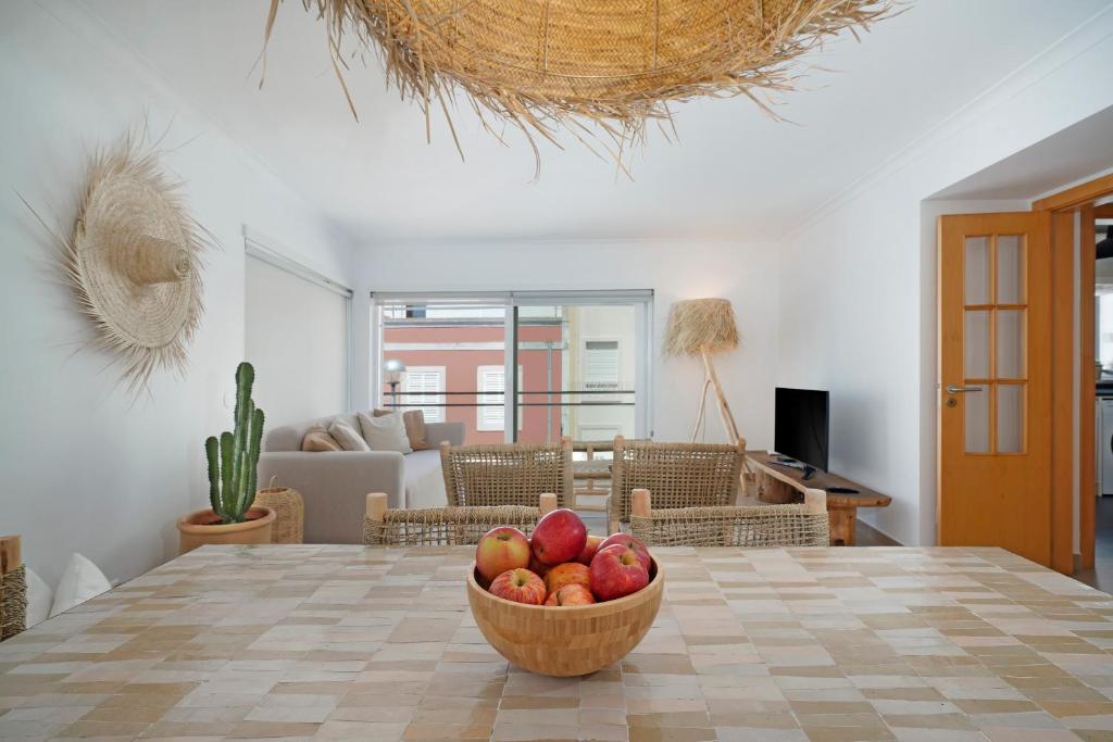 a bowl of fruit on a table in a living room at Boho Chic Beach Duplex in Sesimbra