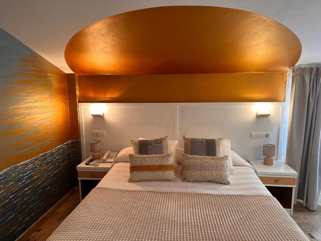 a bedroom with a large bed with a wooden headboard at La Muntanya in Llafranc