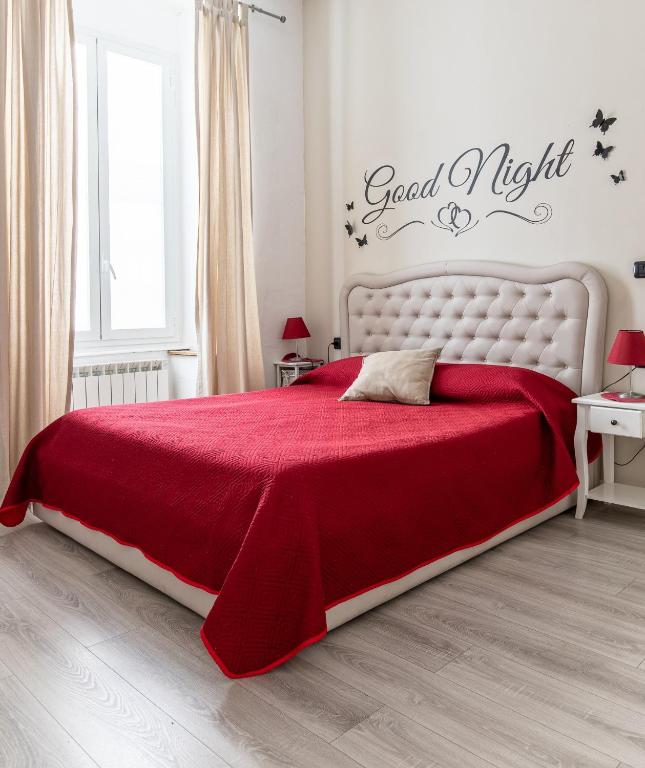 a bedroom with a red bed with a red blanket at Sapore di mare 5 Terre Affittacamere in La Spezia