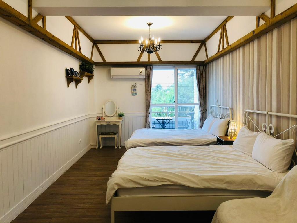 Postel nebo postele na pokoji v ubytování 海沐輕旅 Sea Mu Kenting