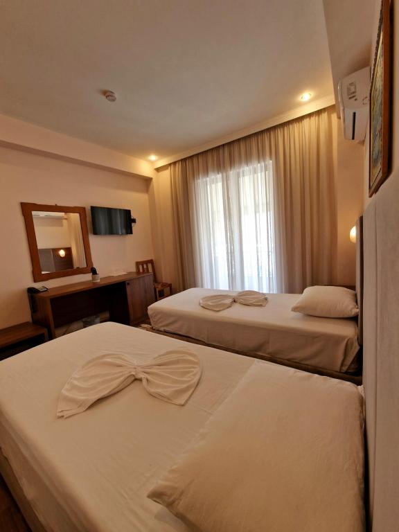 Postel nebo postele na pokoji v ubytování Hotel Kaonia