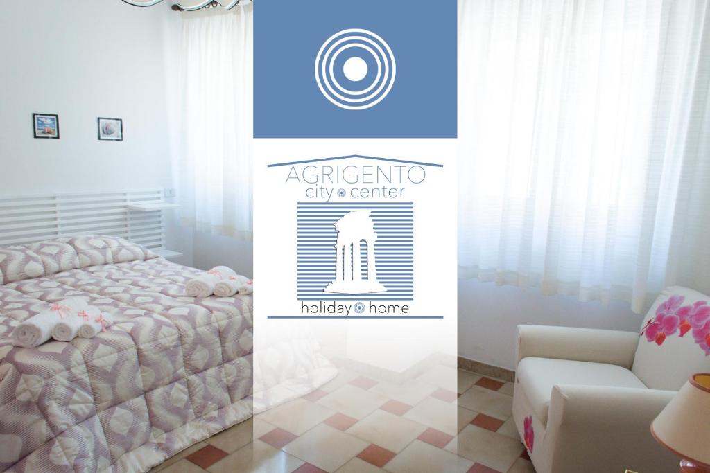 a room with a bed and a sign for a city center at Agrigento CityCenter in Agrigento