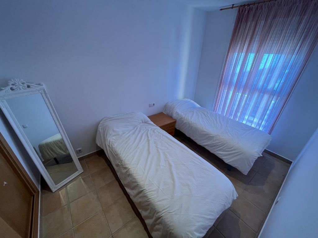 A bed or beds in a room at Adosados Palm Beach Altamar
