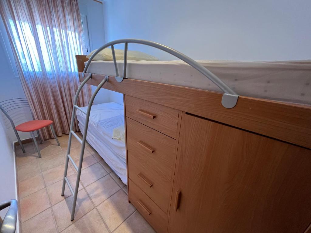 A bed or beds in a room at Adosados Palm Beach Altamar