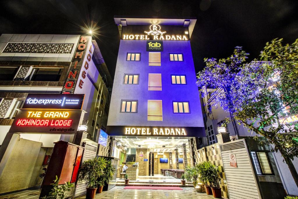 a hotel in the middle of a city at night at Hotel Radana Vashi Navimumbai in Navi Mumbai