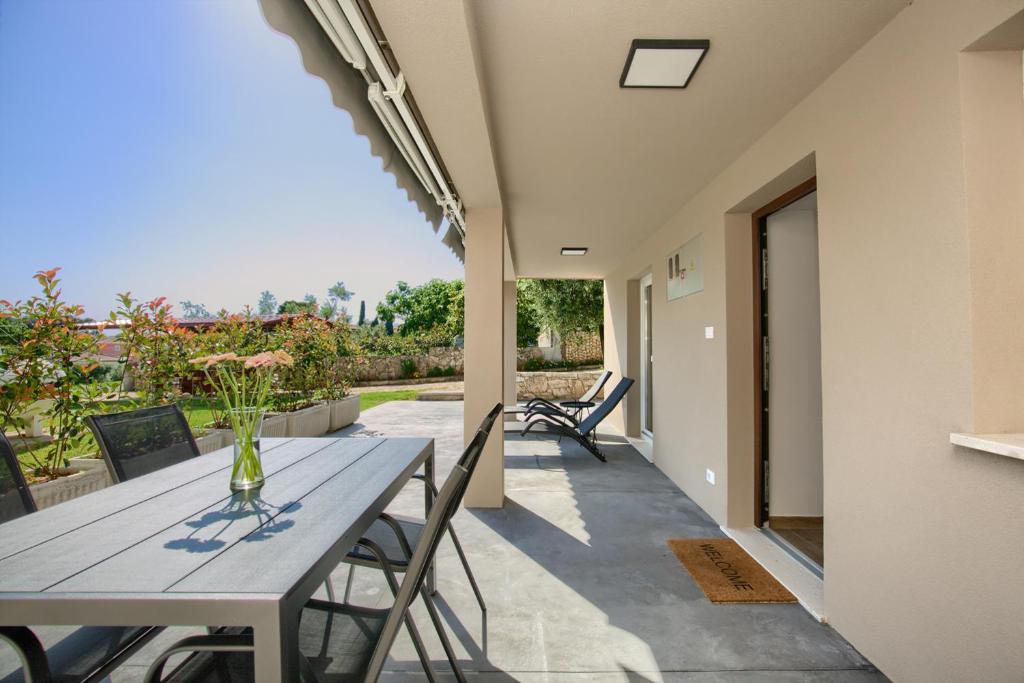a table and chairs on a patio with a view at Apartment Marin 2 near the beach in Banjole