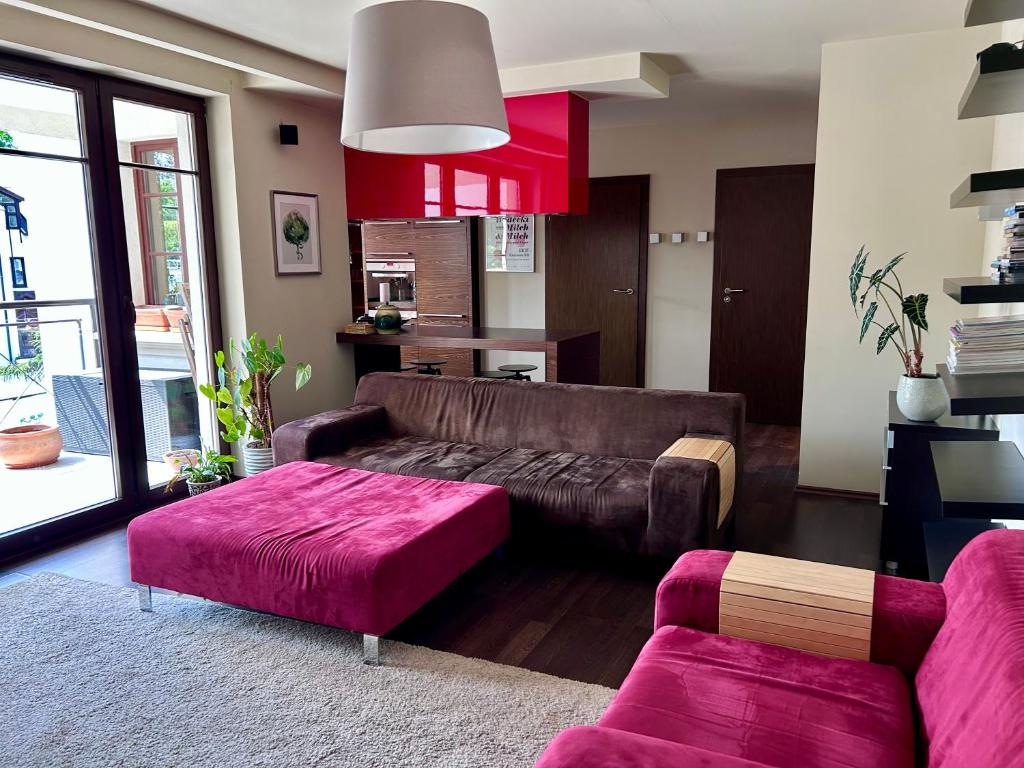 a living room with a brown leather couch at Apartament 3 maja in Sopot
