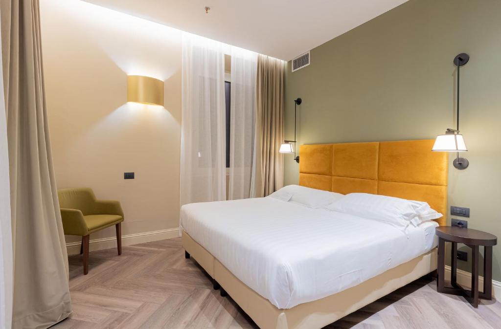 Postel nebo postele na pokoji v ubytování Hotel Astoria