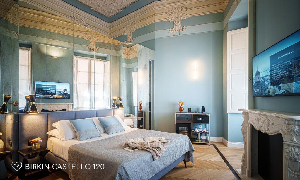 a bedroom with a bed and a tv in it at Albergo Diffuso Birkin Castello in Cagliari