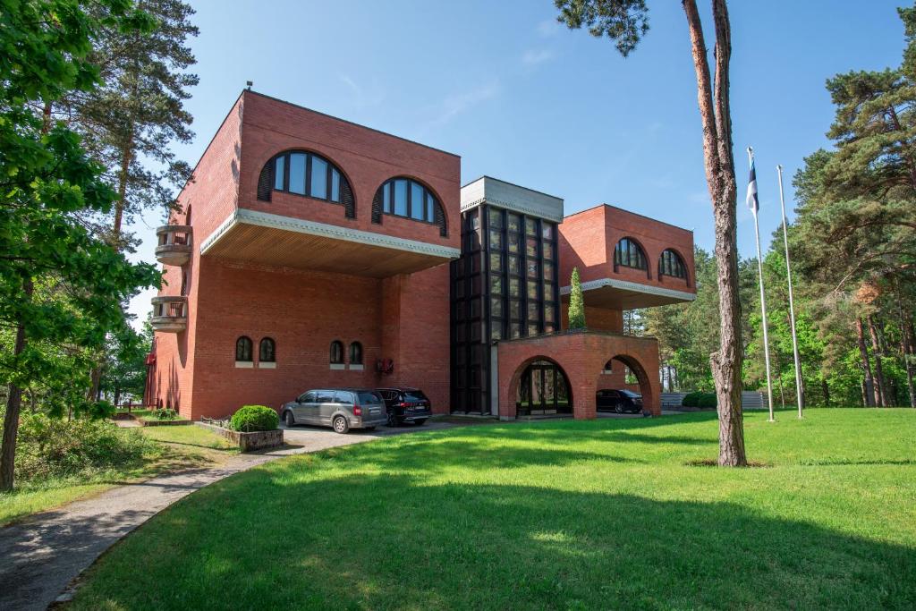 a brick building with a car parked in front of it at Villa Andropoff in Pärnu