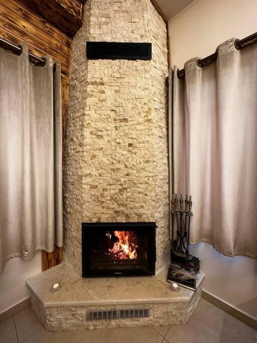 a fireplace in a room with a brick wall at Oak Farm مزرعة البلوط in Ajloun