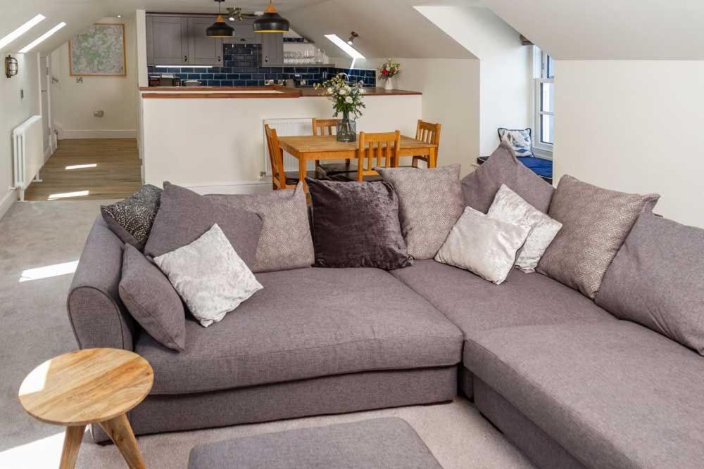 a living room with a gray couch and a table at Stroan in New Galloway