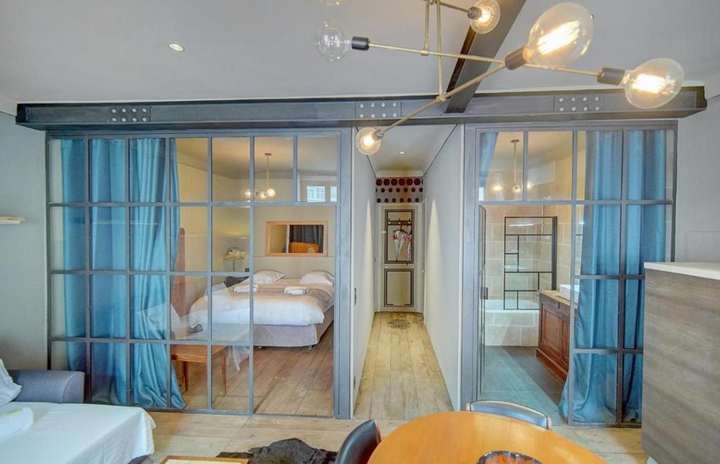 a bedroom with a bed with blue curtains and a room at Red & Bleue YourHostHelper in Cannes