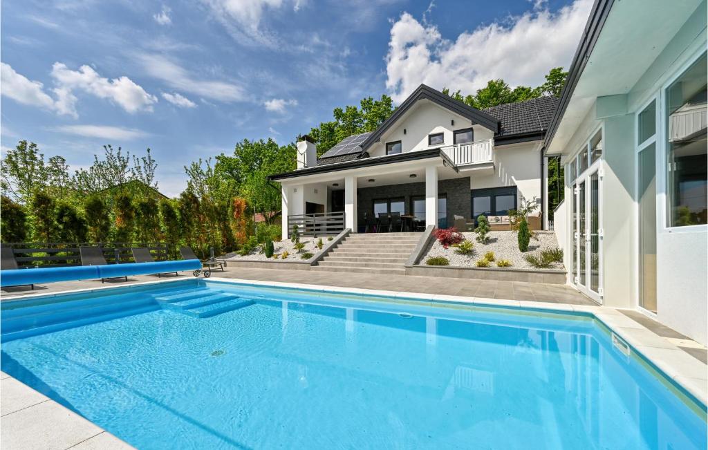 a swimming pool in front of a house at Stunning Home In Stubicke Toplice With Outdoor Swimming Pool, Heated Swimming Pool And Sauna in Stubicke Toplice