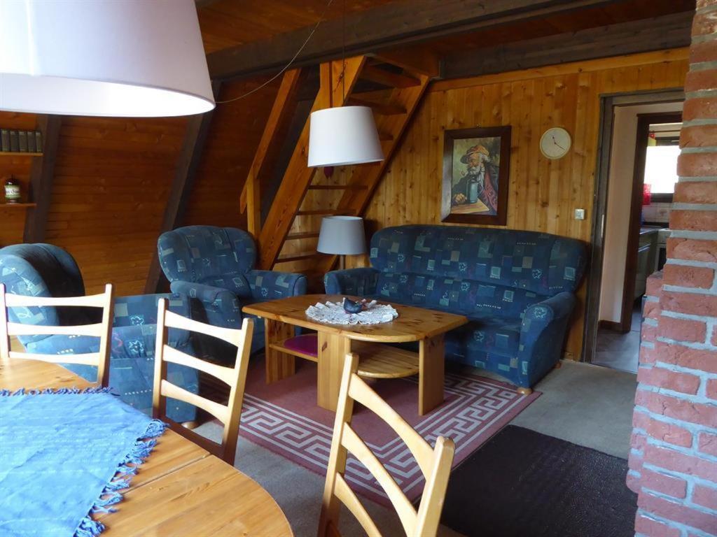 a living room with a couch and a table at Ferienhaus Angret Winkel in Meißendorf