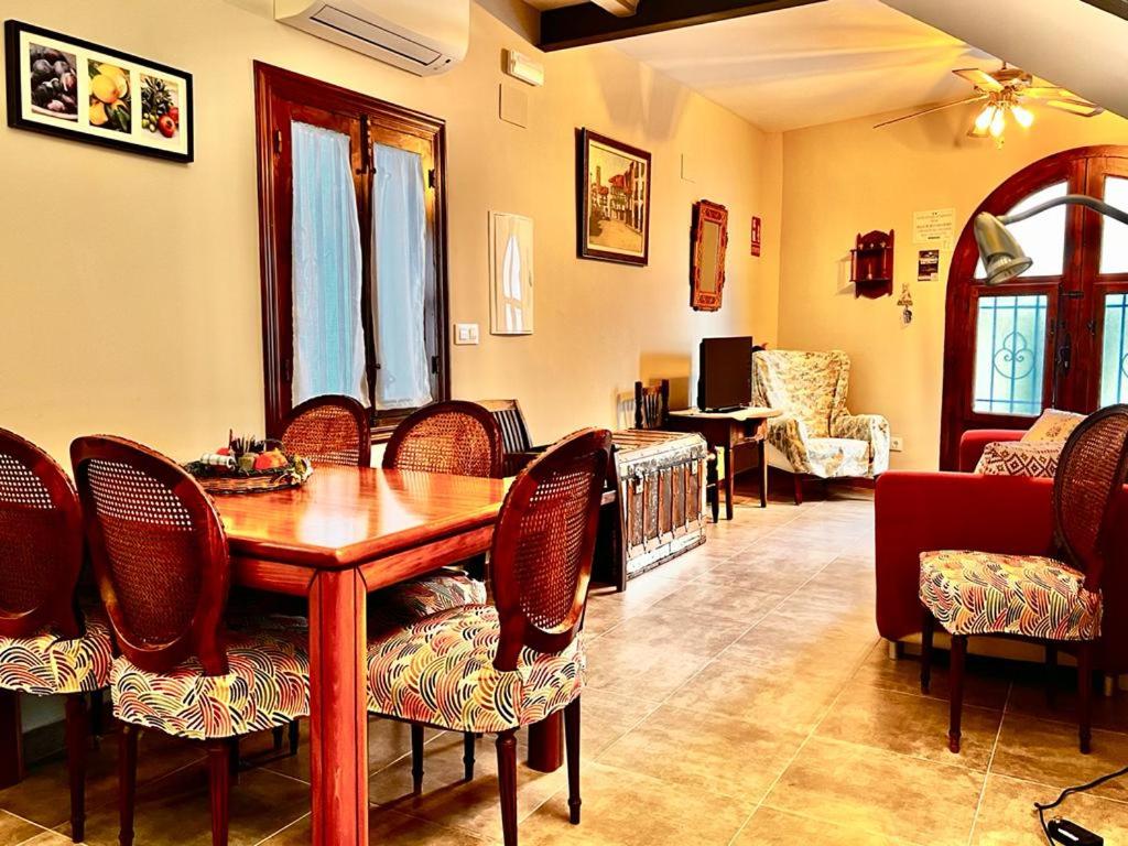 Un comedor con mesa y sillas de madera. en Casa Rural "Calle Real" en La Vera, en Villanueva de la Vera