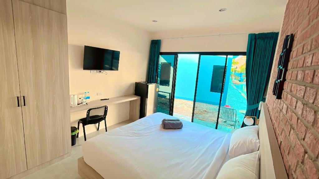 a bedroom with a bed with a view of the ocean at Bests Village & Villa - Chalong Bay Phuket in Chalong