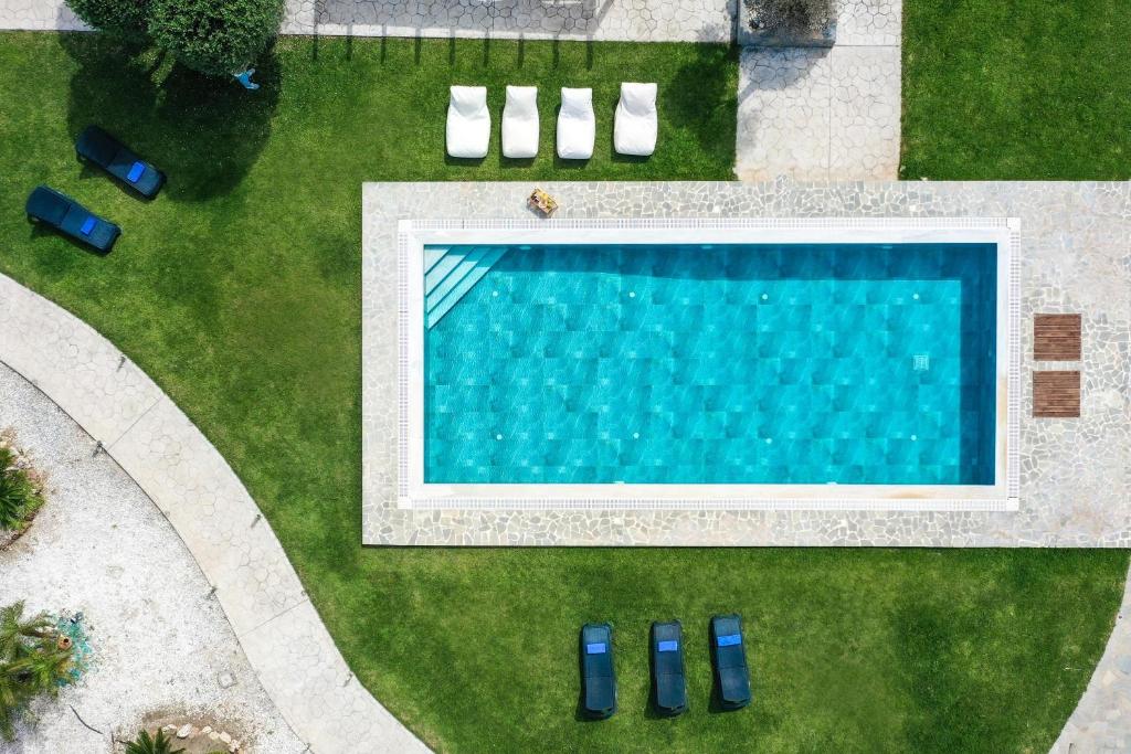 an overhead view of a swimming pool in a lawn at Marble Pool Villa in Pastida
