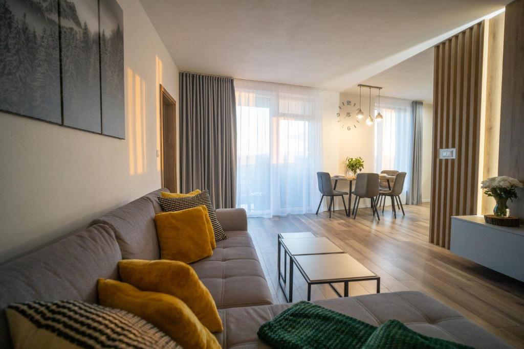 a living room with a couch and a table at Po City Newly Built Apartment in Prešov