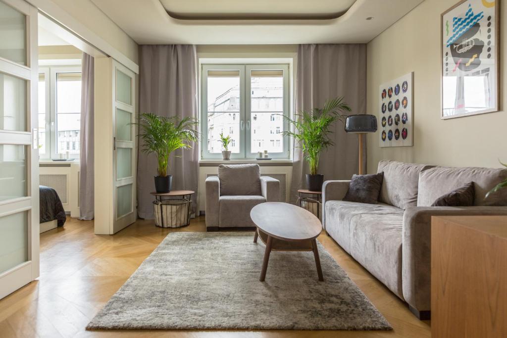 a living room with a couch and a table at Old Town Heart XI - Mokotowska in Warsaw