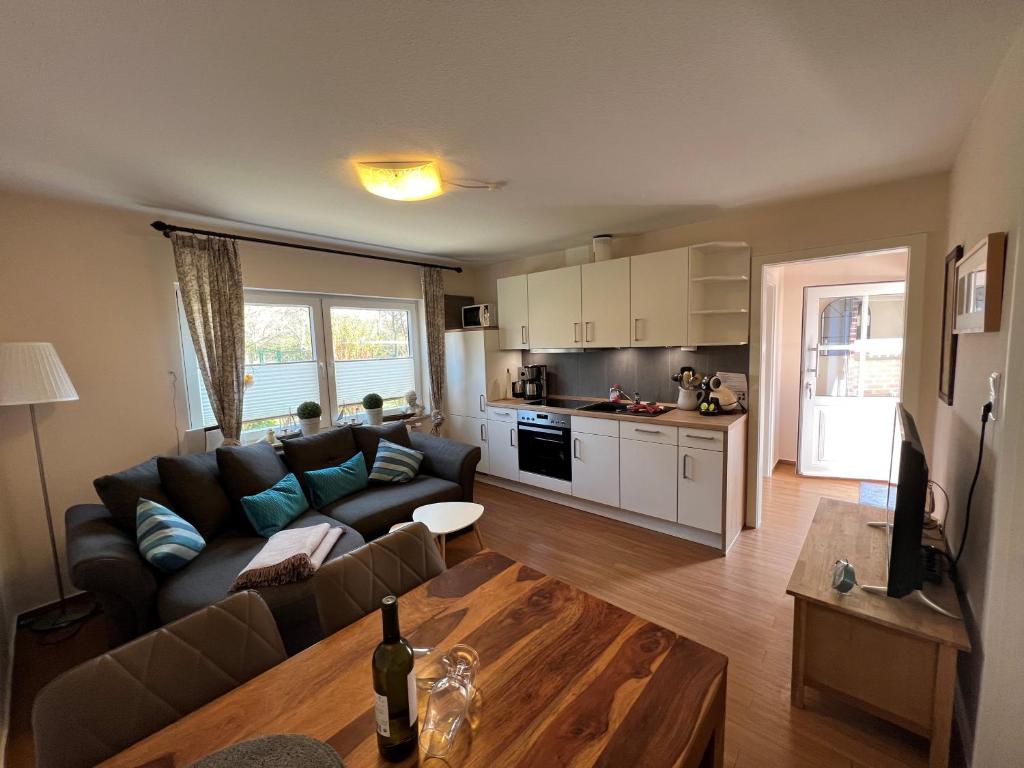 a living room with a couch and a table at Steerenklipp Kieker Bungalow 2 in Borkum