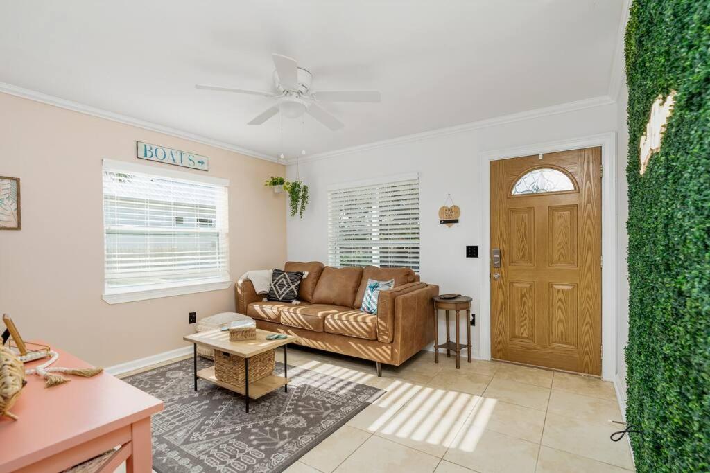 a living room with a couch and a door at Crescent Beach Bungalow B in Saint Augustine